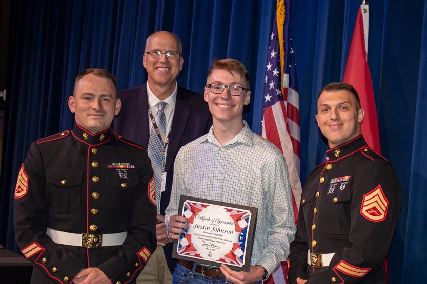 A student is honored for serving in the US Armed Forces after high school
